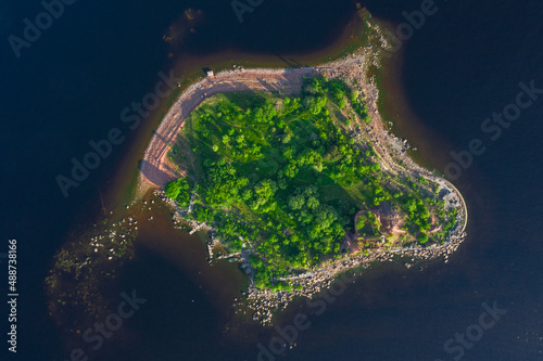 View from the height of the fort Emperor Paul 1 in Kronstadt, the Gulf of Finland, the island of forts, a ruined red brick building in the Gulf of Finland. photo