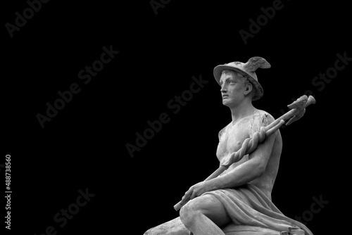 Black and white image of an ancient statue of antique god of commerce, business, merchants and travelers Hermes (Mercury). He also symbolizes cunning. Copy space.