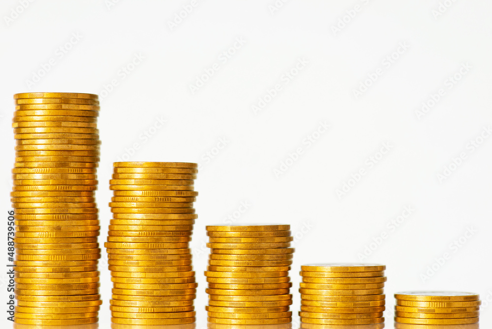 Stacks of golden coins forming going down graph on the white background. Concept of regression in finance, investment, crisis, low GDP rate of the country Stacks of golden coins forming going down graph on the white background. Concept of regression in finance, investment, crisis, low GDP rate of the country