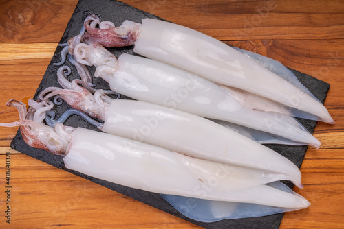 Fresh squid on wooden background,Fresg seafood Squid ready to cook. photo