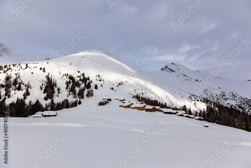 Winter scenery in the European Alps, Graubuenden, Switzerland, with snow-covered mountains, clouds, and sky