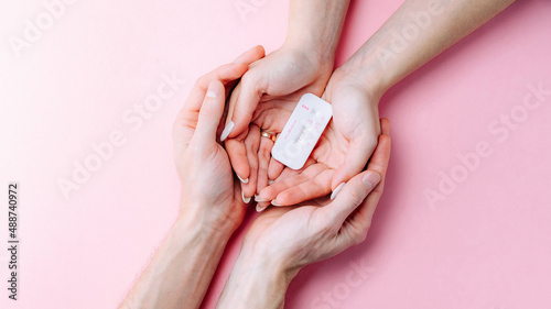 Pregnancy test kit. Female hand hold positive pregnant test with silk ribbon on pink banner background. Medical healthcare gynecological, pregnancy fertility maternity people concept.