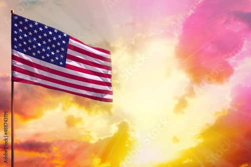 Fluttering USA flag in top left corner mockup with the space for your text on beautiful colorful sunset or sunrise background.