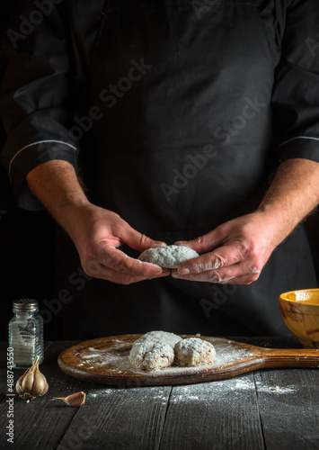 The chef prepares meat cutlets in flour in the kitchen. Recipe for a hotel or restaurant. A national dish