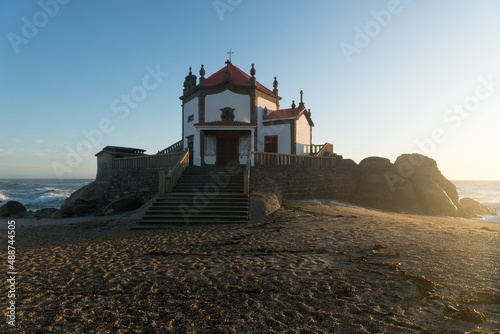 Capela do Senhor da Pedra or Lord of the rock chapel at sunset, Miramar, Portugal photo