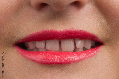 toothy smile of human red lips closeup