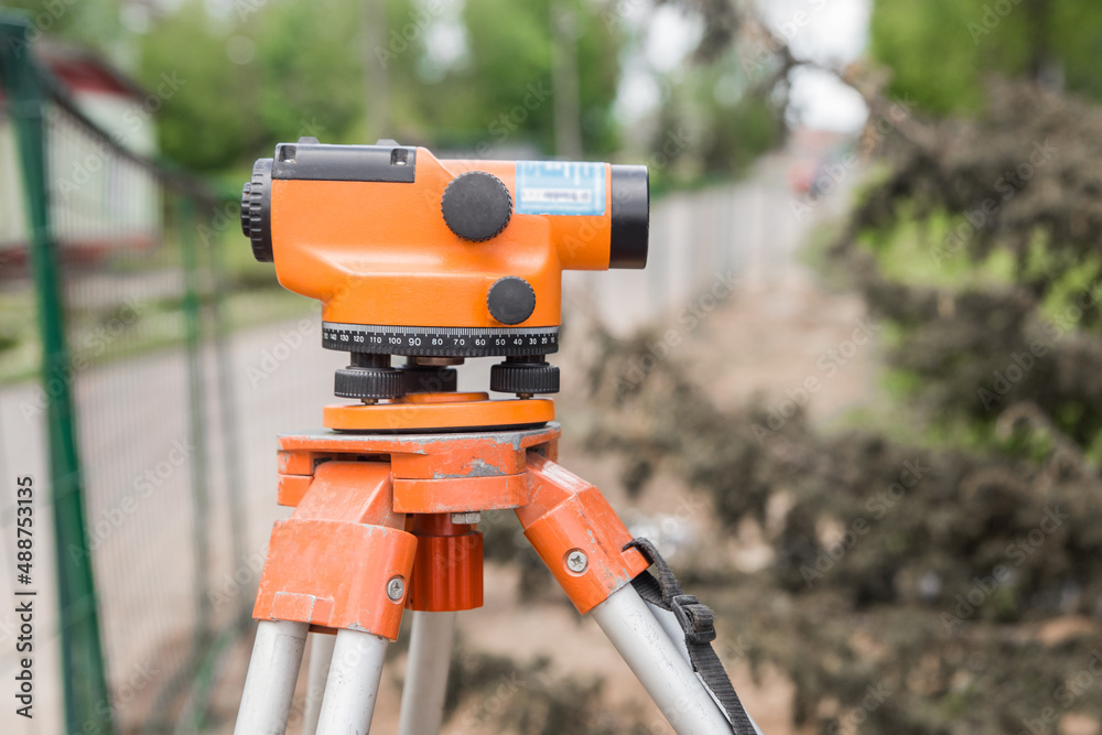 Theodolite tool is a construction measuring instrument in an industrial area or on a construction site survey equipment Theodolite tool is a construction measuring instrument in an industrial area or on a construction site survey equipment