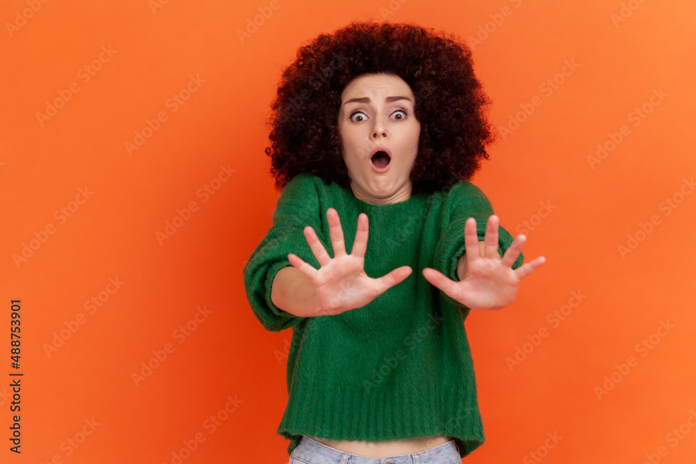 Panic and phobia. Scared female with Afro hairstyle raising hands from ...