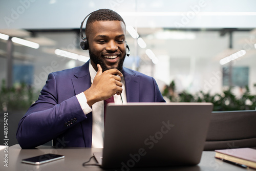 Happy african american manager having video call at office