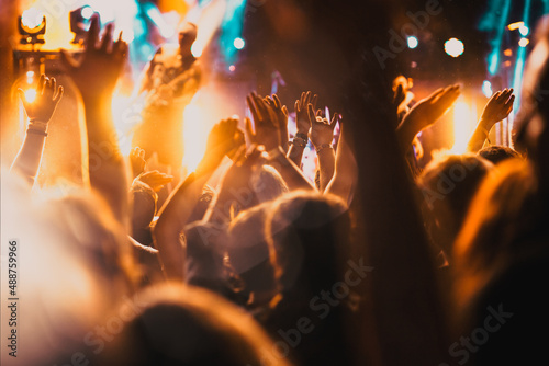 Fototapeta crowd with raised hands at concert - summer music festival