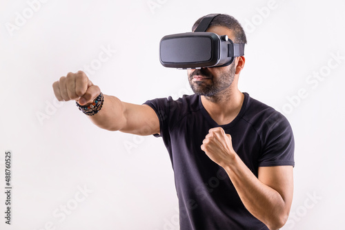 Virtual reality workout, sport game. young man with VR glasses boxing. Smart sport technology 
