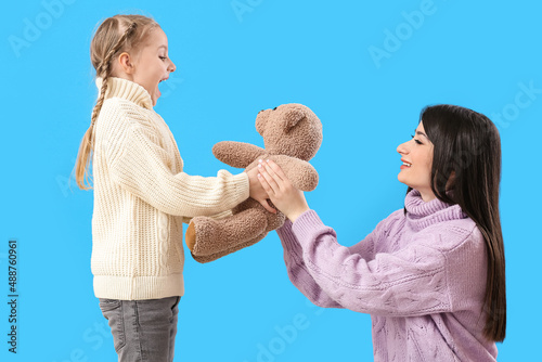 Happy mother giving toy to ...