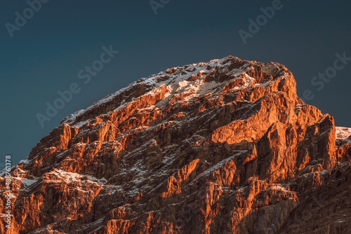 stunning scenery of a snow covered mountain peak at sunset