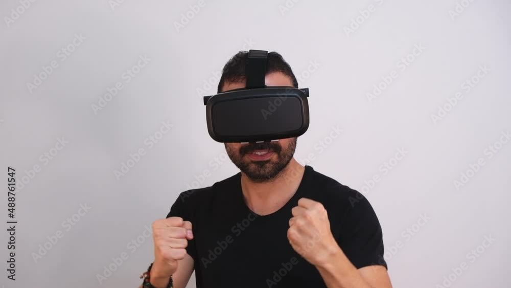 Young man in VR glasses headset gesturing excited portrait. Virtual reality, future technology, education video gaming Young man in VR glasses headset gesturing excited portrait. Virtual reality, future technology, education video gaming