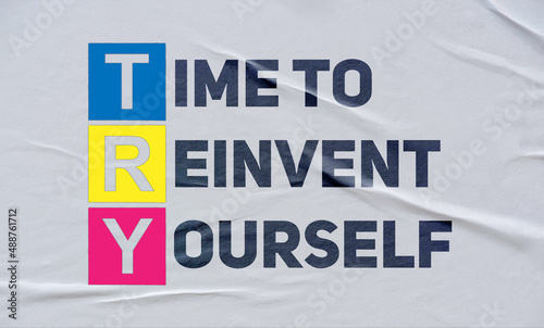 time to reinvent yourself, (TRY), written on white paper photo
