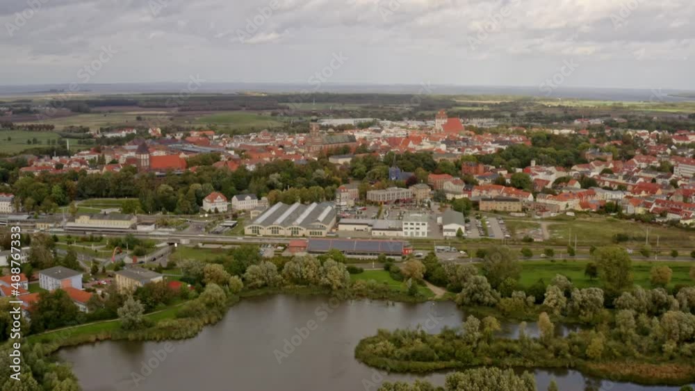 Aerial drone flight over the city of Greifswald during sunset with warm summer light Aerial drone flight over the city of Greifswald during sunset with warm summer light