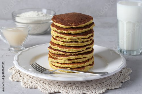 Coconut flour pancakes on white plate on gray background, vegan food