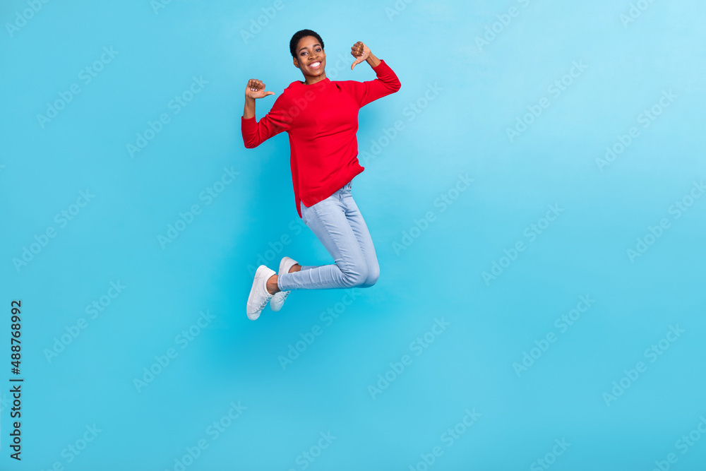Full size photo of beautiful appearance boy girl jumping point fingers herself isolated on blue color background