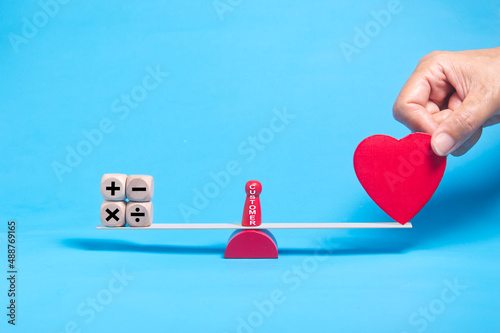 DSC_0638.4 hand holding a red heart make the balance between reason and emotion, customer buying decision concept