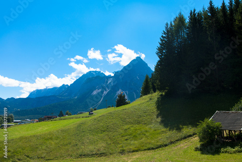 Panoramic view of a idyllic landscape with a mountains and blue sky in the Bavarian Alps against blue sky. Tannheimer Tal, Reutte, Austria