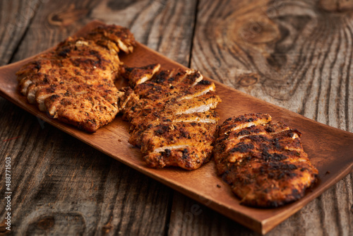 Fried chicken breast on a wooden board