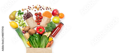 Healthy food background. Healthy food in paper bag vegetables and fruits on white, vegetarian eating. Food delivery, shopping food supermarket concept