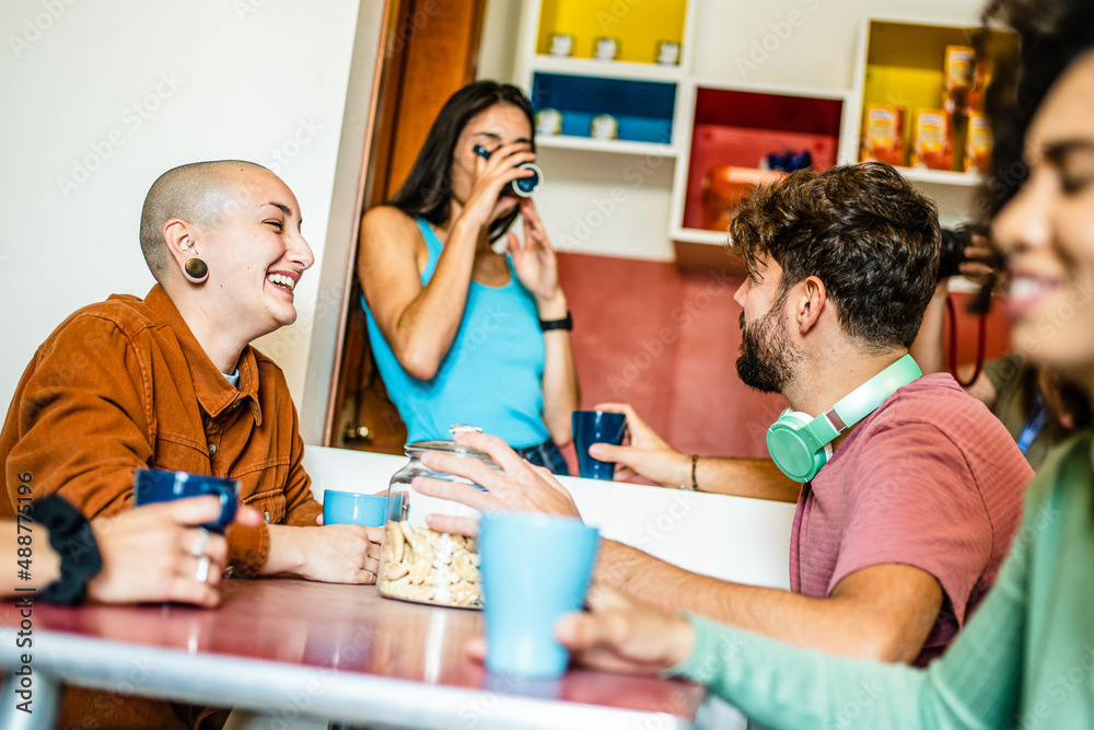 Group of young people having breakfast at coffee bar of an hostel, friends talking and having fun together at living room, diverse gen z people at brunch on vacation - obrazy, fototapety, plakaty 