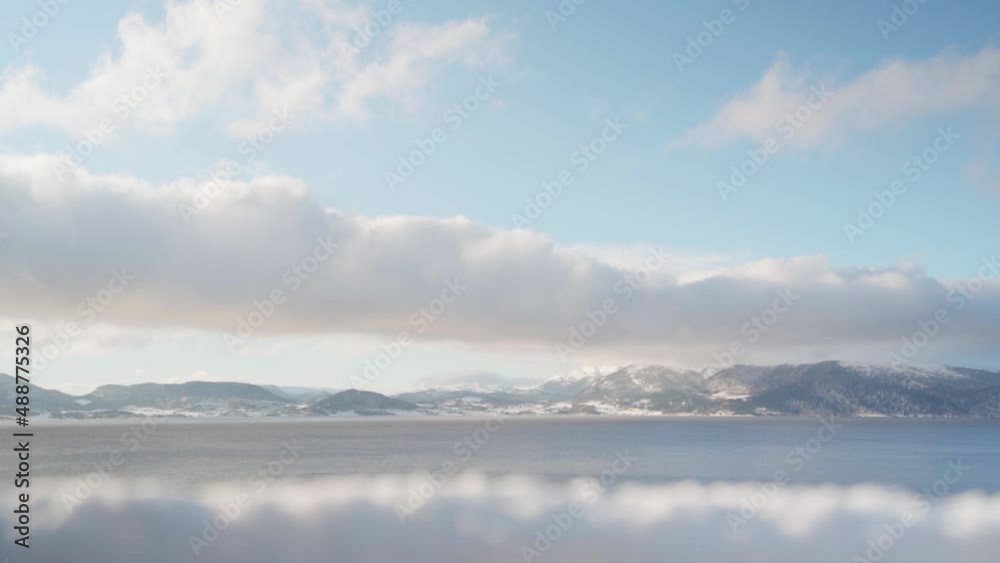 White Clouds Moving In The Fjord And Mountain Range At Daytime. - timelapse White Clouds Moving In The Fjord And Mountain Range At Daytime. - timelapse
