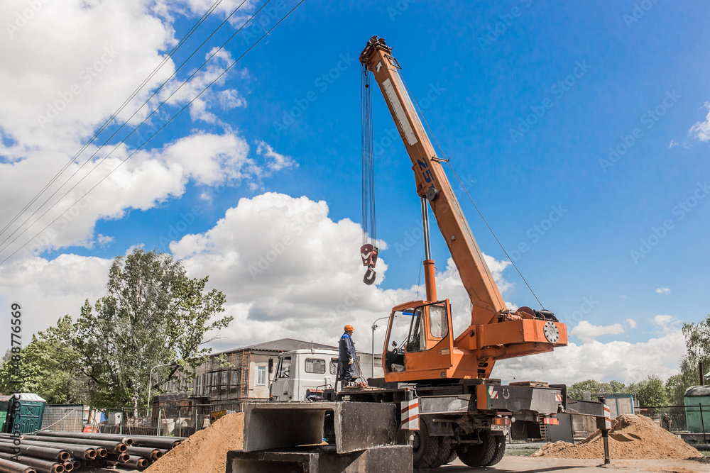 Belarus, Minsk region - May 20, 2020: Machine Beam Crane Heavy Lifting Industry Vehicle Construction Work on Industrial Site