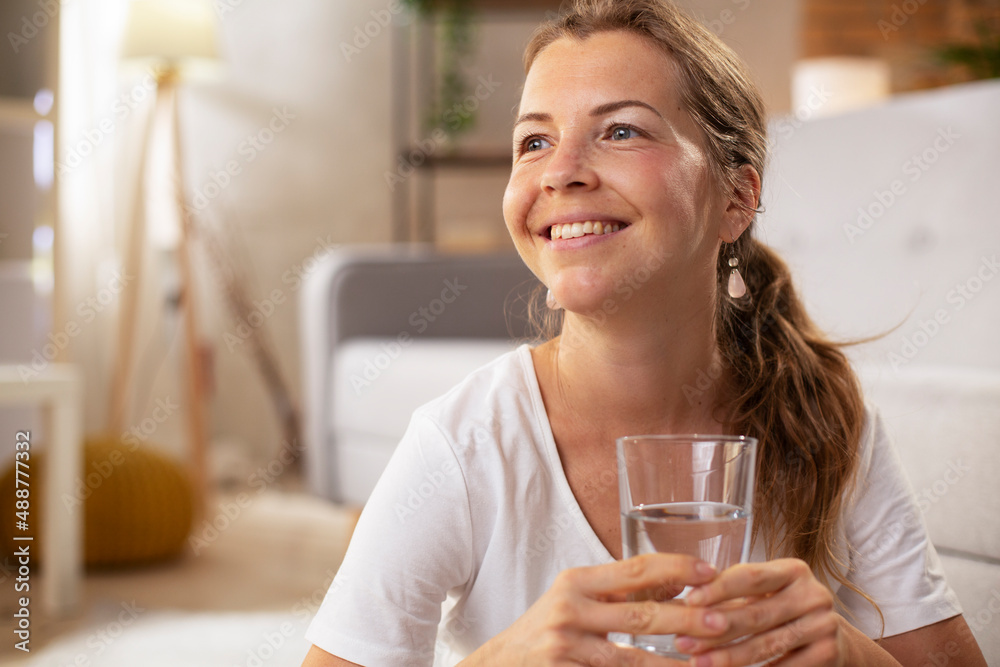 Girl holding a glass of water. Smiling girl drinking water Girl holding a glass of water. Smiling girl drinking water