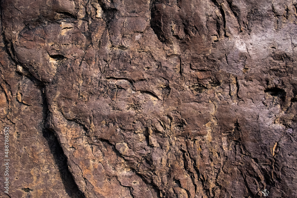 Closeup of rock surface. Textured rough dark surface. Rock wall background.