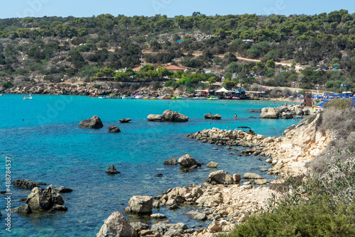 Crystal clear blue water of Mediterranean sea and yellow rocks in on Konnos beach near Protaras, Cyprus