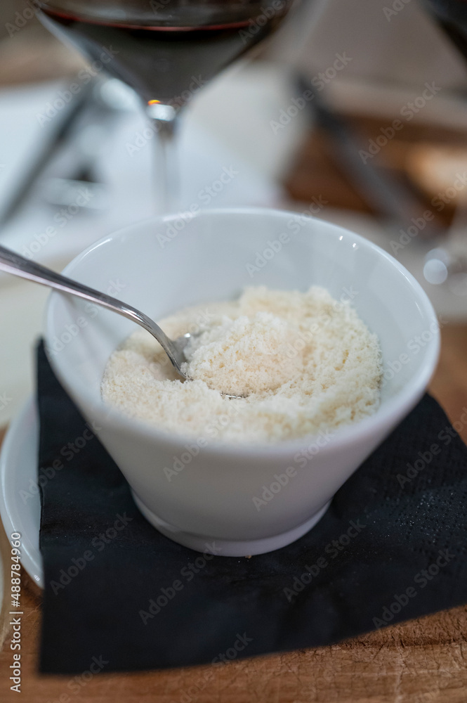 Bowl with grated parmesan Parmigiano-Reggiano hard cheese in Parma, Emilia Romagna, Italy Bowl with grated parmesan Parmigiano-Reggiano hard cheese in Parma, Emilia Romagna, Italy