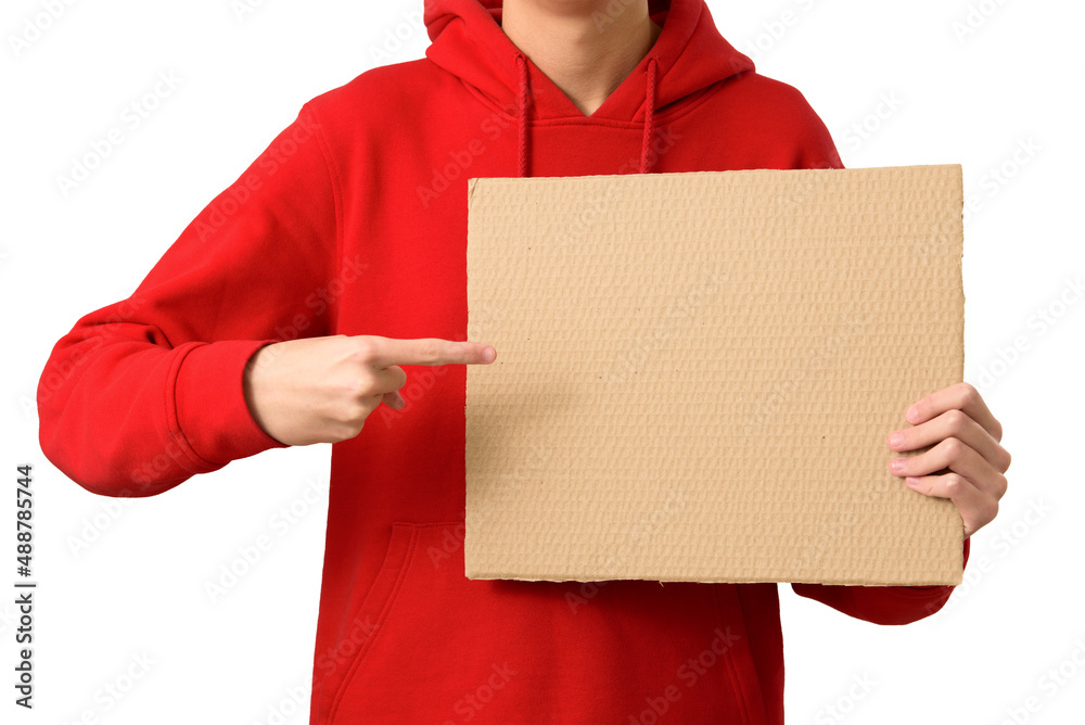 Hands of teenager holding blank brown cardboard banner and pointing index finger in copy space, isolated on white background. Job search, sale, ad promo concept. Closeup.