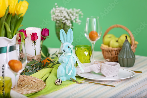 Easter rabbit and dinnerware on served table