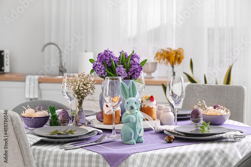 Dining table served for Easter celebration in light kitchen