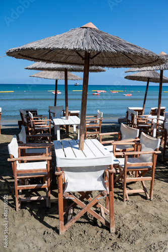 Beach unbrellas and chairs on sunny sandy beach Lady's mile in Akritori, Cyprus © barmalini