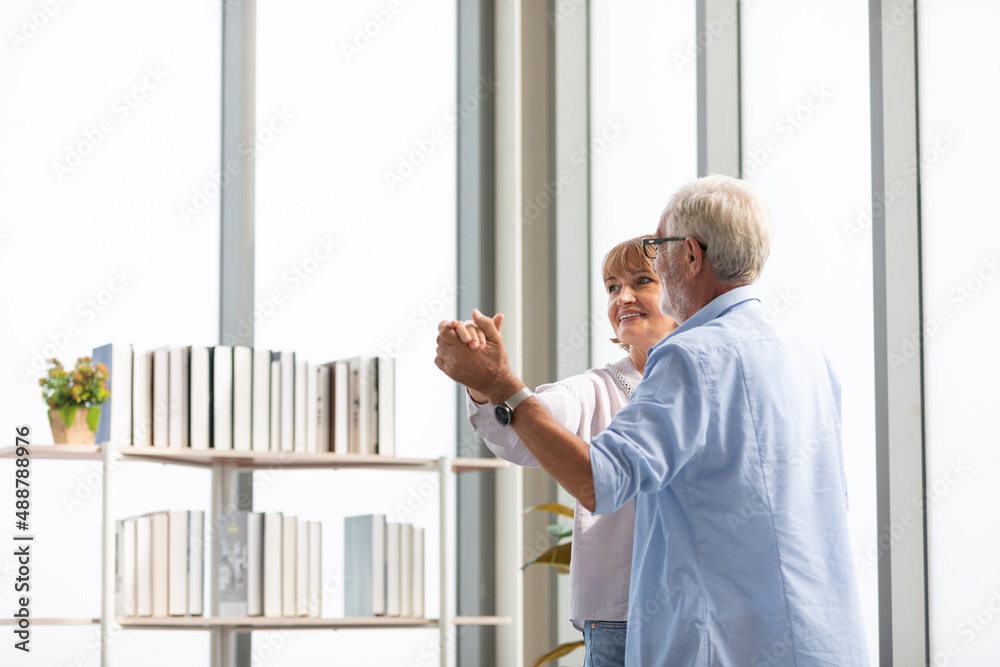 Fototapeta premium senior couple, elderly man and woman dancing together at home