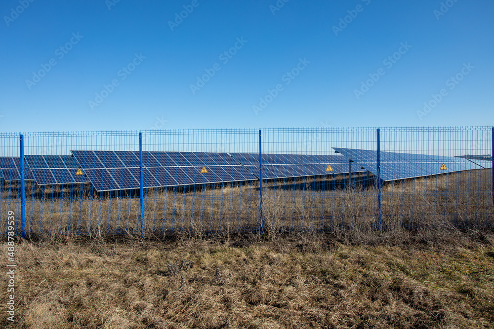 Private Solar panel field behind a protective fence Private Solar panel field behind a protective fence