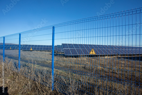 Private Solar panel field behind a protective fence