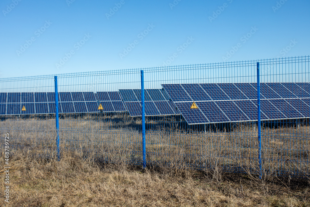 Private Solar panel field behind a protective fence Private Solar panel field behind a protective fence