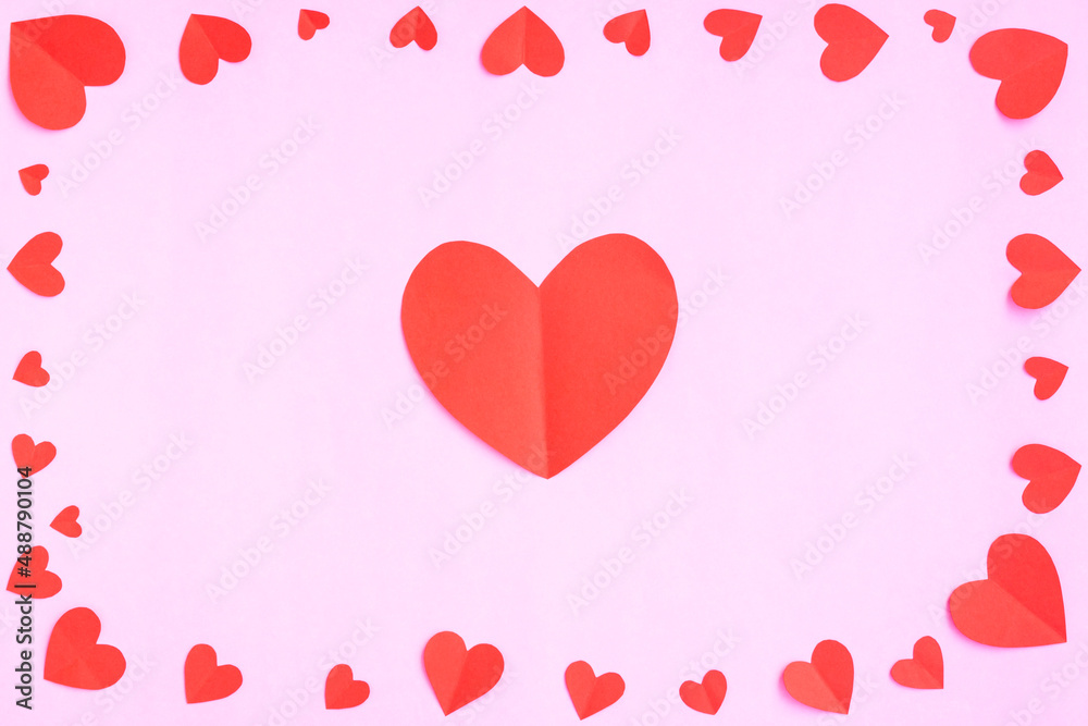 Red hearts papercut on pink background