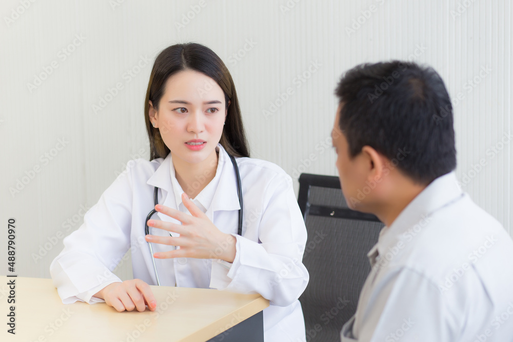 Asian professional woman doctor suggests healthcare solution to her patient elderly in examination room at hospital. Asian professional woman doctor suggests healthcare solution to her patient elderly in examination room at hospital.