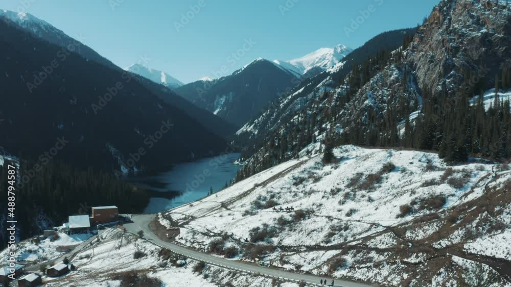 This stock motion graphics shows a mountain landscape. Travelers on ...