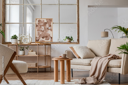 Stylish compositon of modern living room interior with beige sofa  abstract painting  wooden commode  side table and elegant home accessories. Home staging. Template. Copy space.