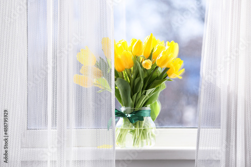 Fototapeta Naklejka Na Ścianę i Meble -  Bouquet of beautiful yellow tulip flowers on windowsill