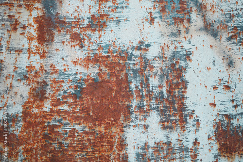 grunge rusty old and dirty metal plate covered with peeling paint