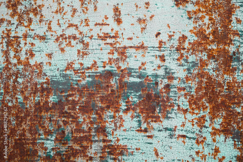 grunge rusty metal plate covered with blue peeling paint