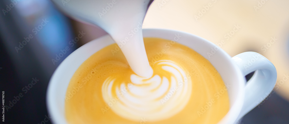 barista pouring milk into espresso coffee for making cappuccino, latte art barista pouring milk into espresso coffee for making cappuccino, latte art
