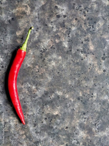 red hot chili peppers on the rusty concrete background with copy space